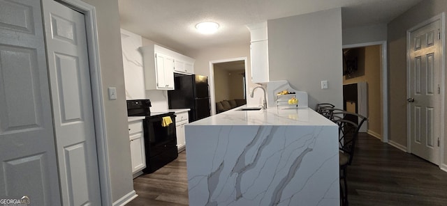 kitchen featuring sink, white cabinets, light stone counters, black appliances, and dark wood-type flooring