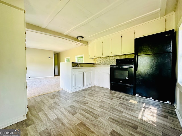 kitchen with beam ceiling, black appliances, decorative backsplash, light carpet, and sink