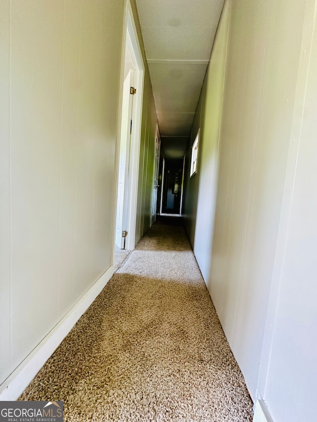 hallway featuring light colored carpet