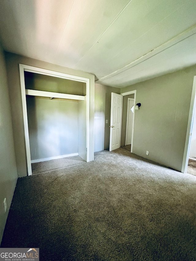 unfurnished bedroom featuring carpet floors and a closet