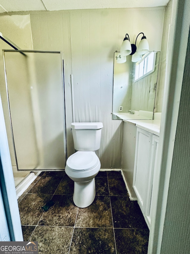 bathroom featuring an enclosed shower, vanity, tile patterned floors, and toilet