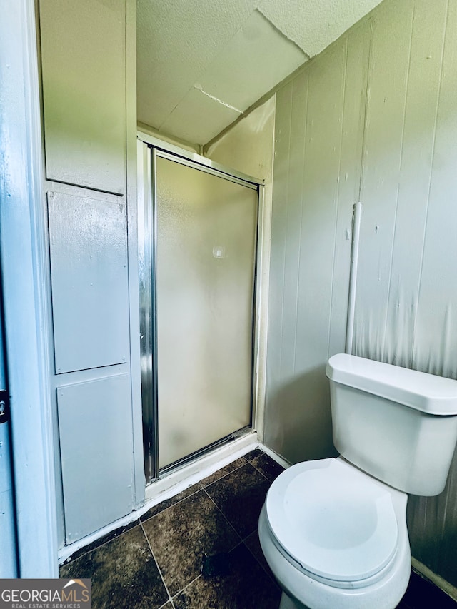 bathroom featuring walk in shower, tile patterned flooring, toilet, and a textured ceiling