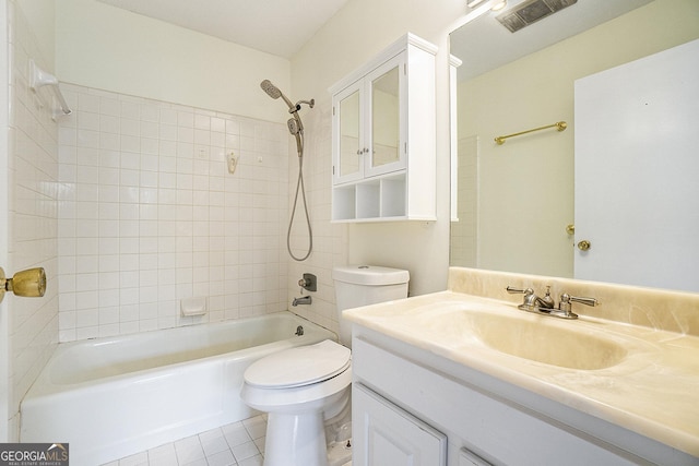 full bathroom featuring vanity, tile patterned floors, toilet, and tiled shower / bath