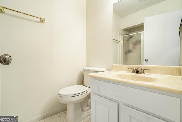 bathroom featuring walk in shower, vanity, toilet, and tile patterned flooring