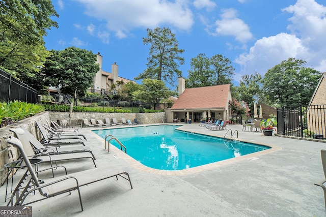 view of swimming pool with a patio