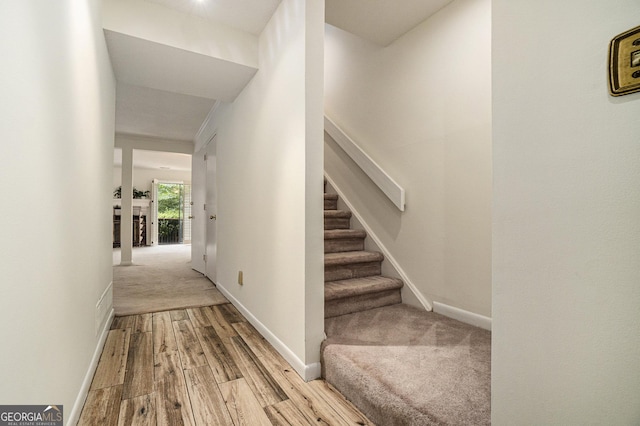 stairs featuring wood-type flooring