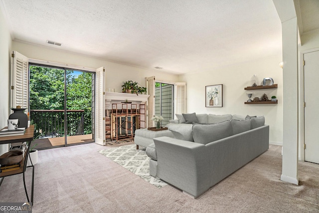 carpeted living room featuring a brick fireplace and a textured ceiling