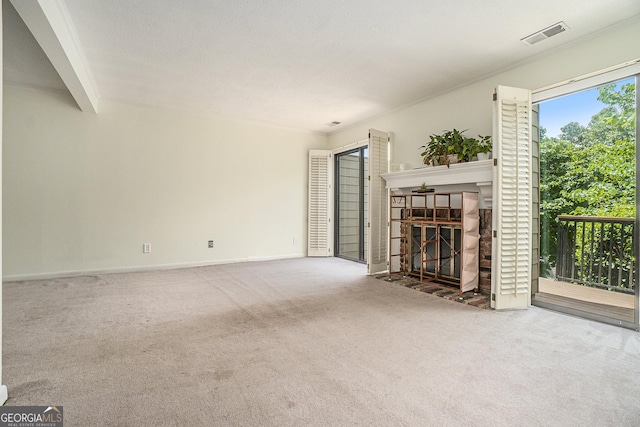 unfurnished living room featuring a tile fireplace and carpet