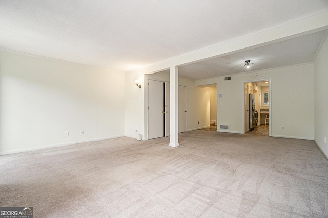 carpeted empty room featuring crown molding