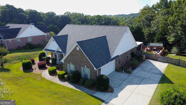 drone / aerial view featuring a view of trees