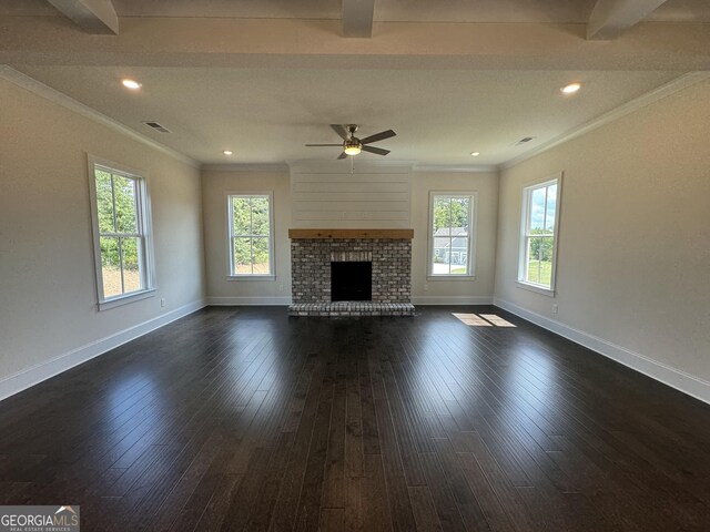 unfurnished living room featuring dark wood-type flooring, ceiling fan, beam ceiling, and a fireplace