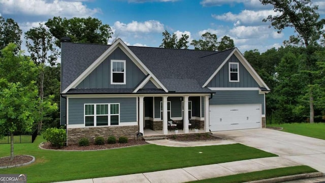 craftsman-style home with covered porch and a front yard