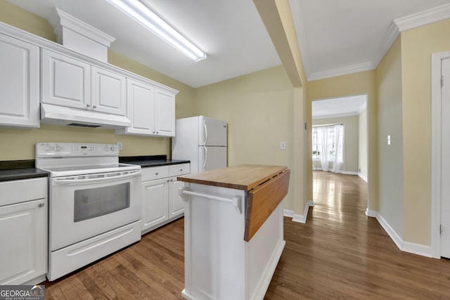 kitchen featuring under cabinet range hood, butcher block counters, white cabinetry, and white appliances