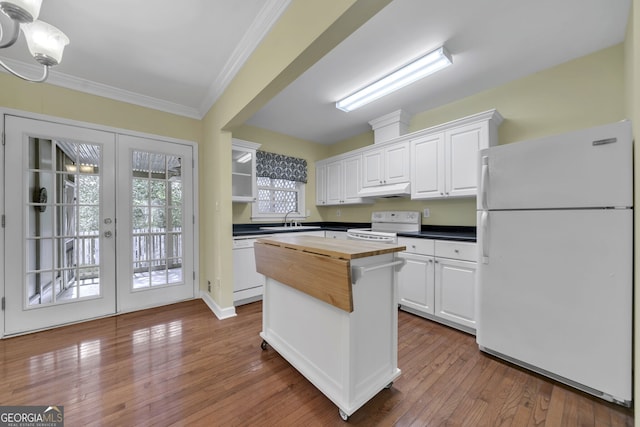 kitchen featuring french doors, wooden counters, white cabinets, a sink, and white appliances