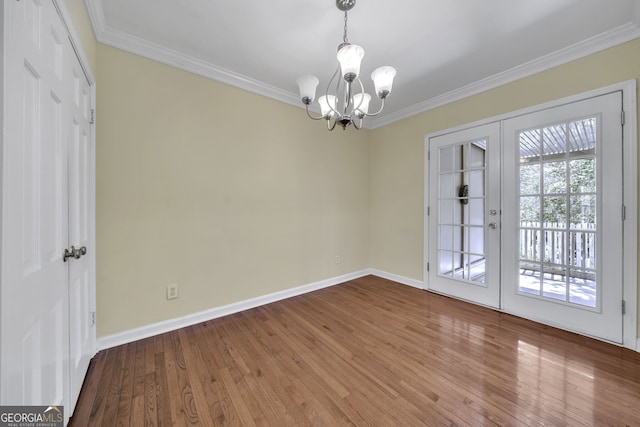 unfurnished dining area featuring ornamental molding, french doors, and hardwood / wood-style flooring