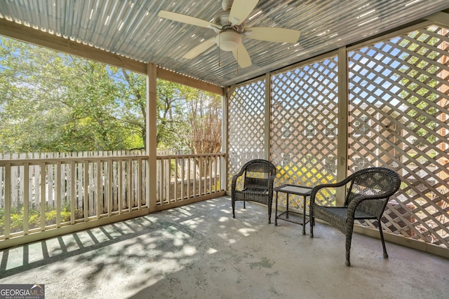 unfurnished sunroom with ceiling fan