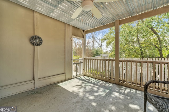 unfurnished sunroom with a ceiling fan