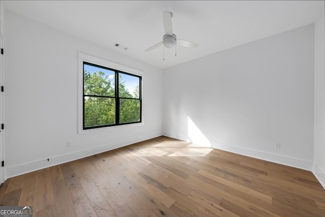 spare room featuring light wood-type flooring and ceiling fan