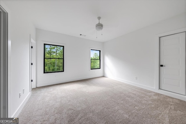 spare room with light carpet and ceiling fan