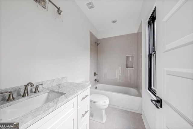 full bathroom with vanity, tiled shower / bath combo, toilet, and tile patterned flooring