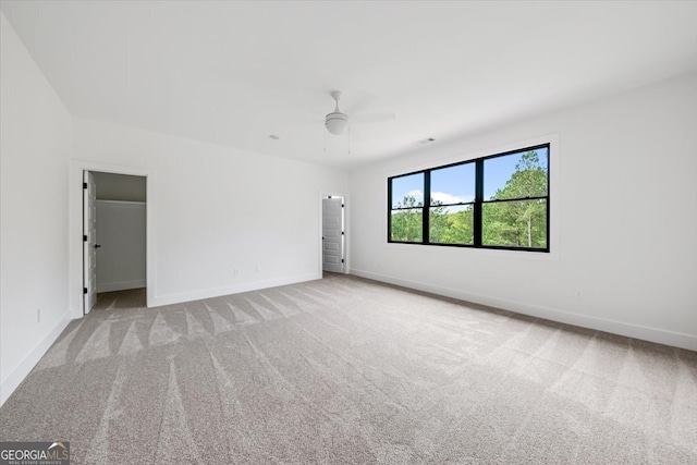 carpeted empty room with ceiling fan