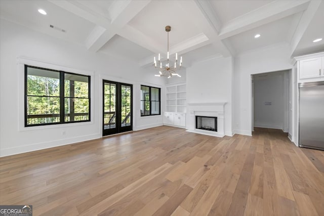 unfurnished living room with coffered ceiling, beam ceiling, and light hardwood / wood-style flooring