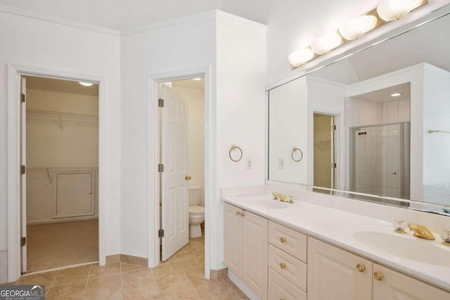 bathroom featuring tile patterned flooring, vanity, walk in shower, toilet, and crown molding