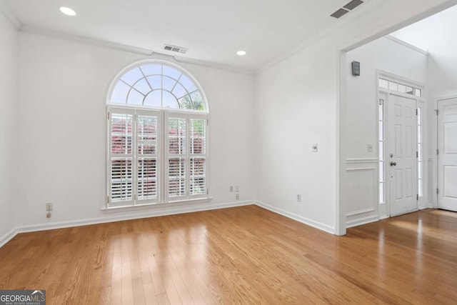 interior space with ornamental molding and light wood-type flooring