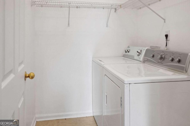 laundry room with light tile patterned floors and independent washer and dryer