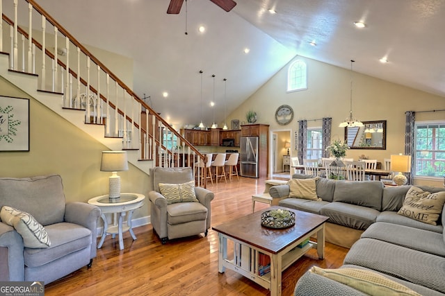 living room featuring high vaulted ceiling, ceiling fan, and hardwood / wood-style flooring