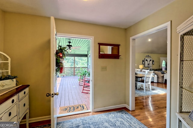 doorway to outside with ceiling fan and light hardwood / wood-style flooring