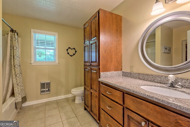 full bathroom featuring shower / bath combo with shower curtain, tile patterned floors, toilet, and vanity