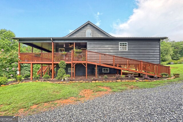 rear view of property with a deck and a yard