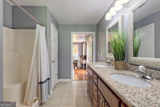 bathroom with dual vanity and wood-type flooring