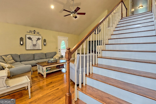 living room with wood-type flooring, ceiling fan, and vaulted ceiling