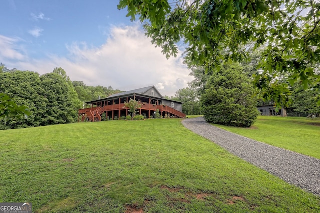 view of front of home featuring a deck and a front lawn