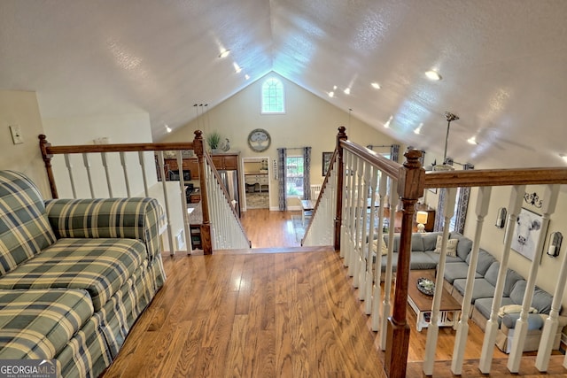 living room with vaulted ceiling and light wood-type flooring