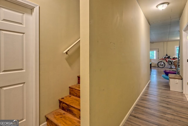 stairs featuring hardwood / wood-style floors