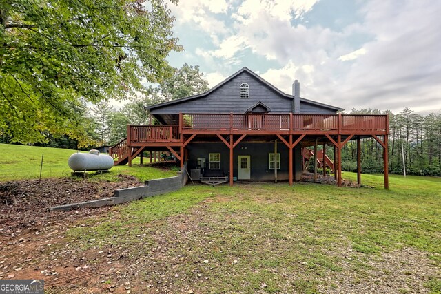 back of house featuring a yard and a deck