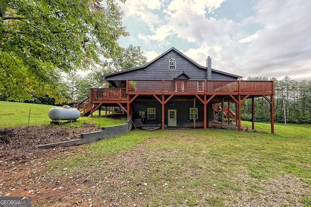 back of house featuring a wooden deck and a lawn