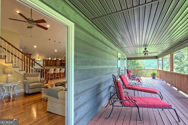 wooden deck featuring a porch and ceiling fan