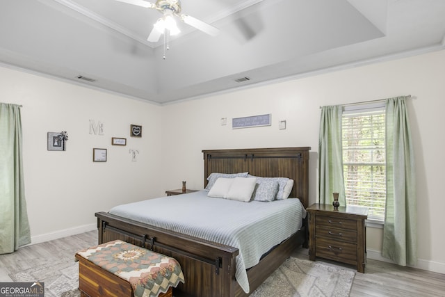 140 Wisteria Blvd, Covington, GA 30016 - bedroom with light wood-style flooring, visible vents, multiple windows, and a raised ceiling