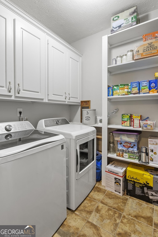 140 Wisteria Blvd, Covington, GA 30016 - clothes washing area featuring cabinet space, a textured ceiling, and independent washer and dryer