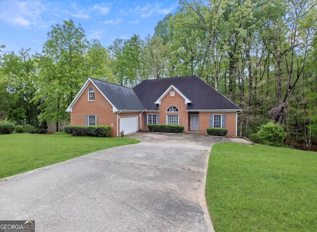 view of front of property with a garage and a front lawn