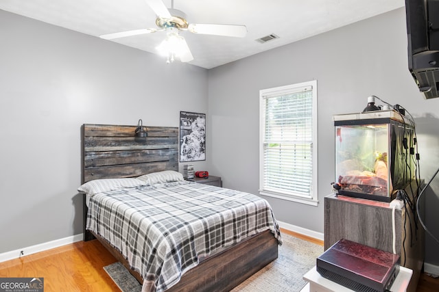 bedroom with light hardwood / wood-style floors and ceiling fan