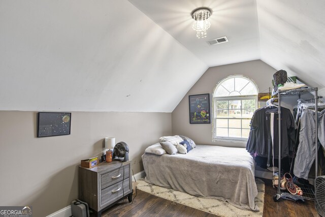 140 Wisteria Blvd, Covington, GA 30016 - bedroom featuring lofted ceiling, baseboards, visible vents, and dark wood-type flooring