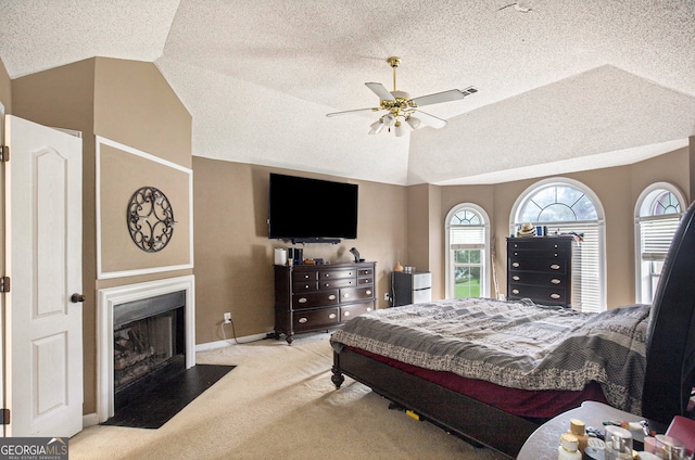 bedroom with a textured ceiling, carpet floors, and ceiling fan