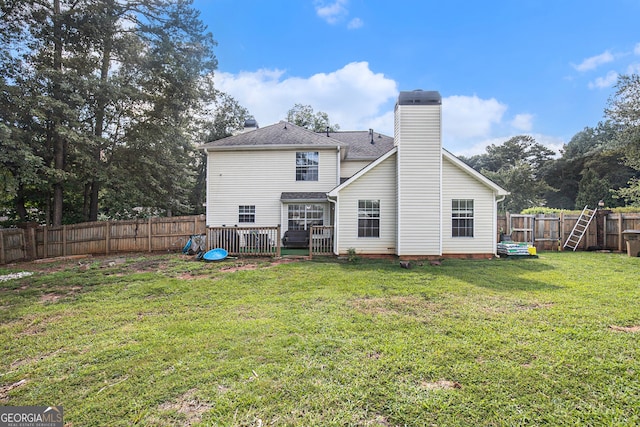 back of house featuring a lawn