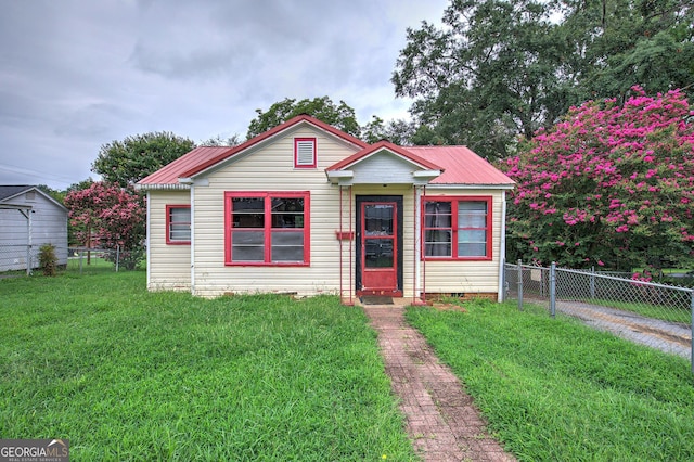 bungalow-style home with a front yard