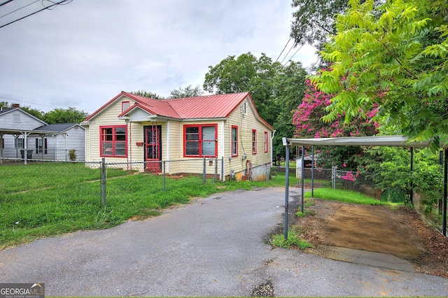 bungalow featuring a front yard and a carport